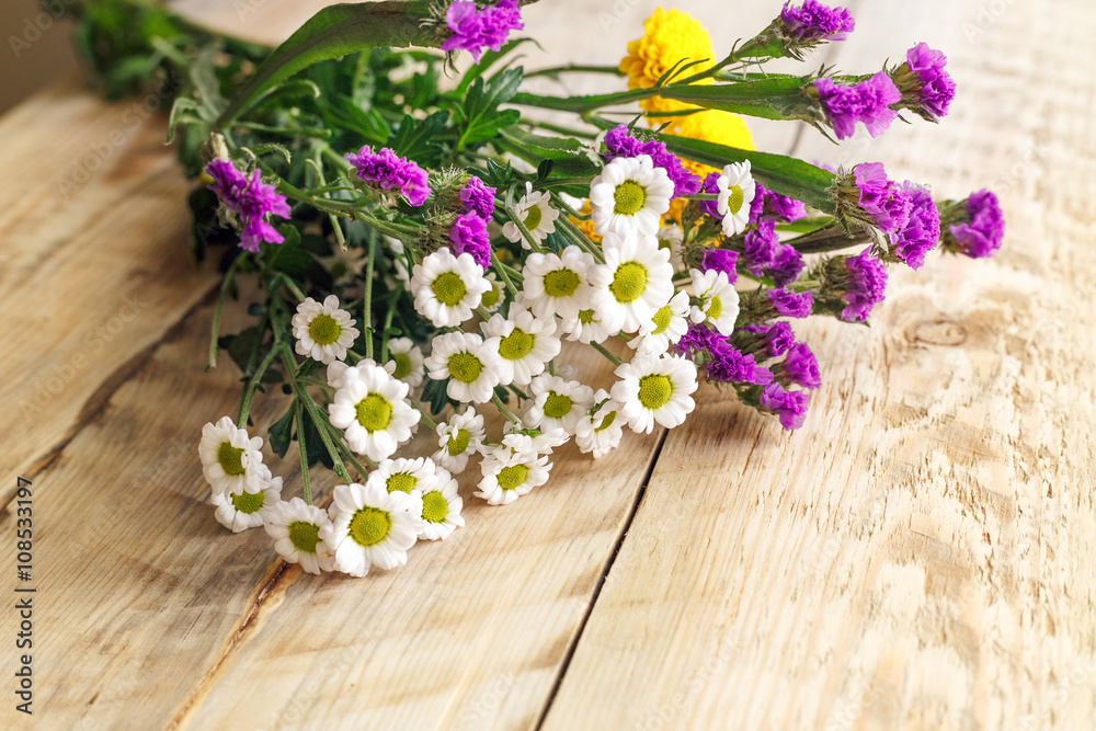 bouquet spring flowers on wooden board