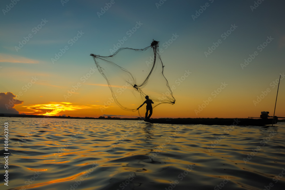 Fisherman through the net in the river.Thailand.