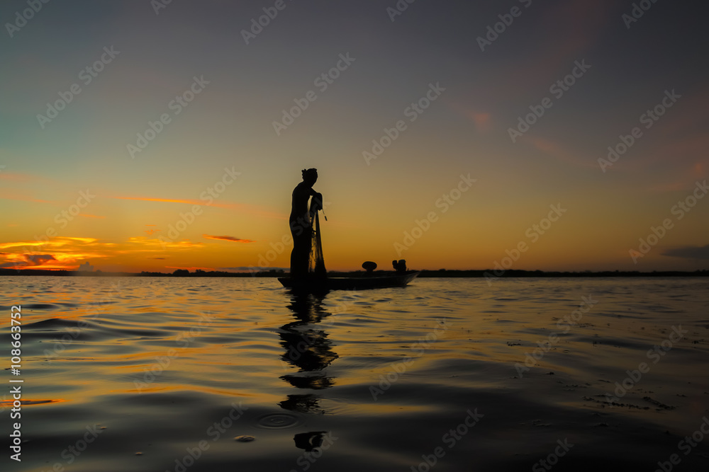 Fisherman through the net in the river.Thailand.