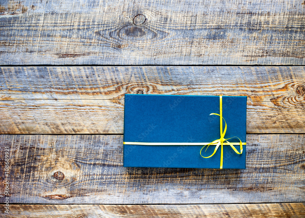 blue gift box on empty wooden table 