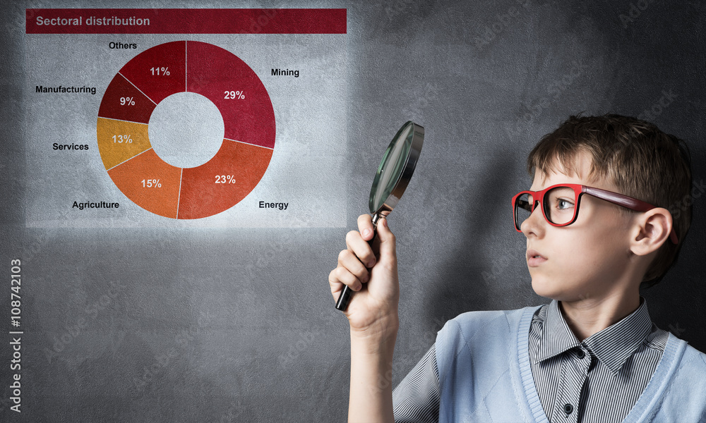 Curious school boy with magnifier