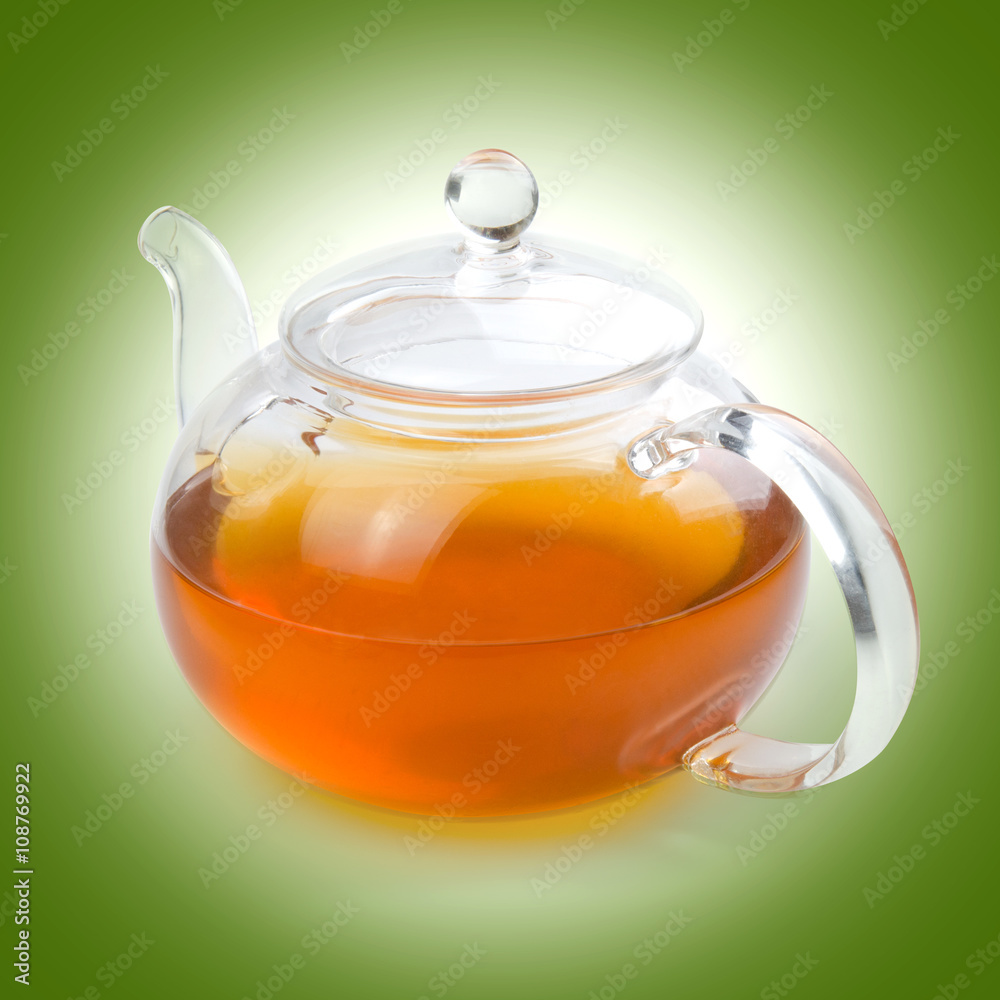 Teapot glass with tea isolated on a beige background with clipping path. Front view.