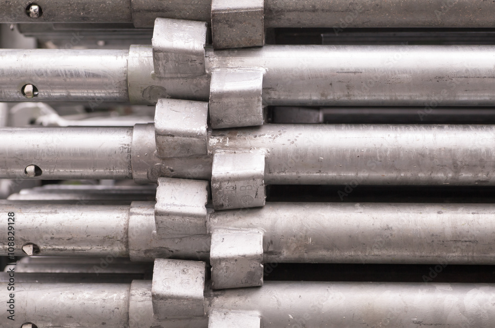 Close - up Stack of construction metal pipes .