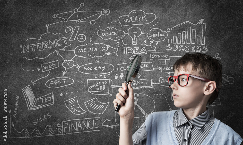 Curious school boy with magnifier