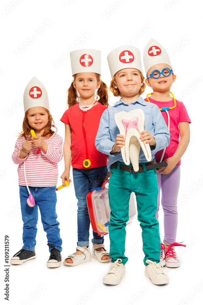 Little doctors with tooth model and toy instruments