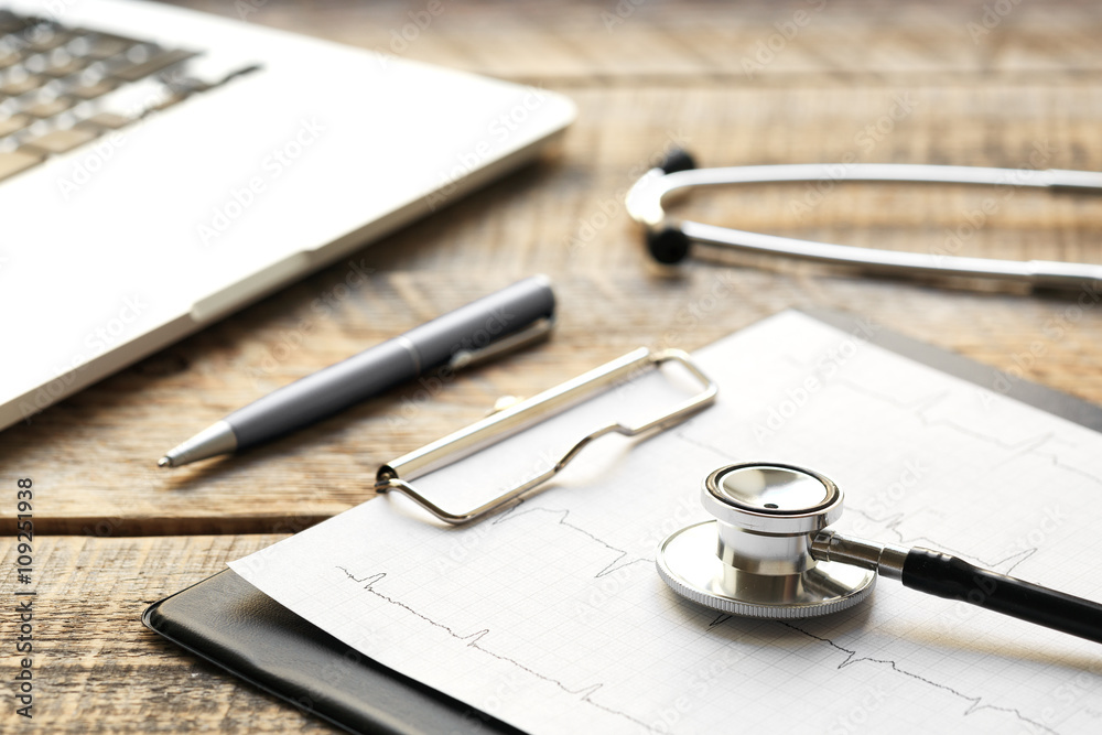 doctor workplace with a stethoscope at wooden table