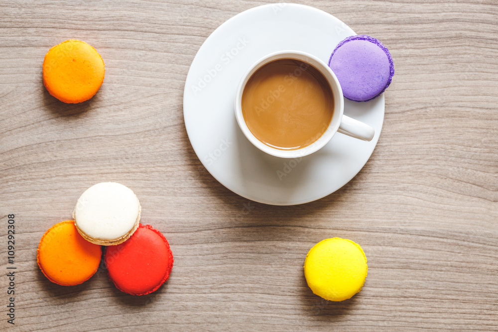 sweet breakfast with coffee and macaroons on wooden table