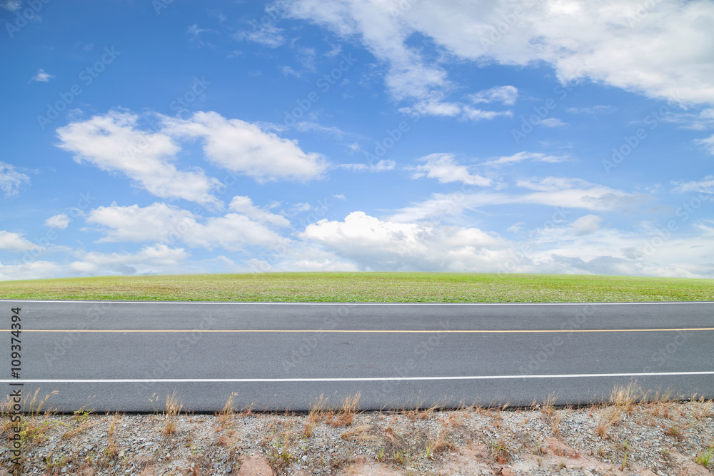 Asphalt Road with green grass ,blue sky background.