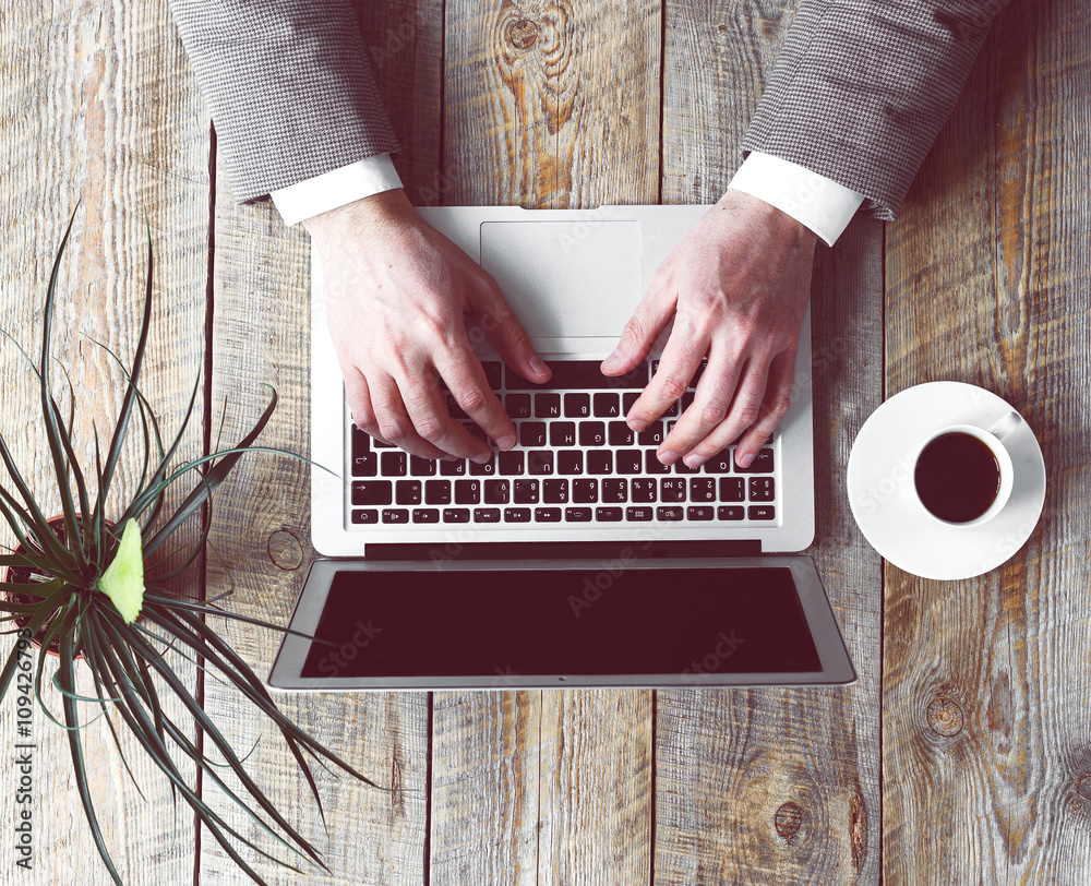 Mans working place at wooden table with office worker