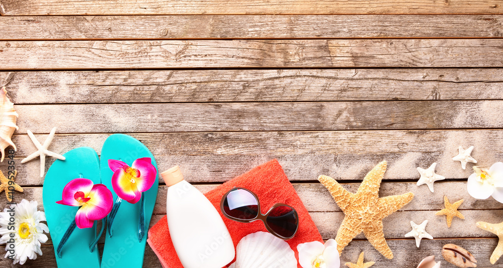 Beach accessories on wooden background