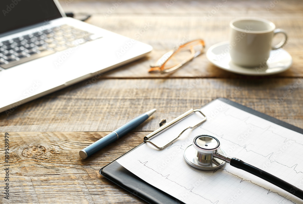 doctor workplace with a stethoscope at wooden table