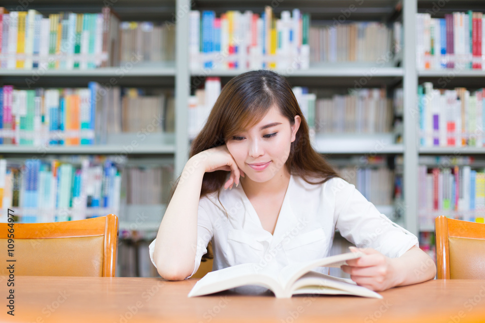 young beautiful asian girl in school library