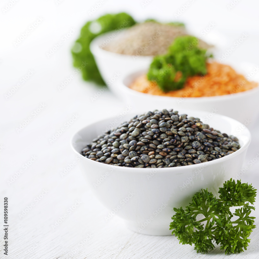 Bowls of assorted dried lentils with red lentils, black beluga l