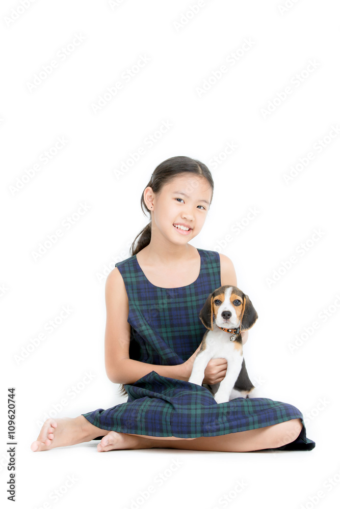 Happy Asian girl playing with beagle puppy on isolated background