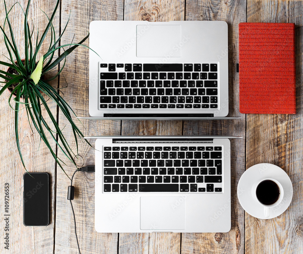 Working place for two with notebook on wooden table