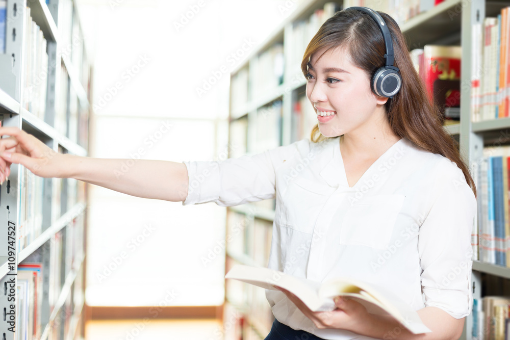 young beautiful asian girl university student in library