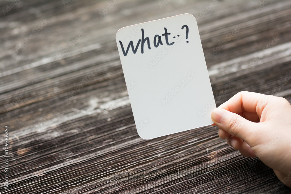 holds card with text on old wood plate