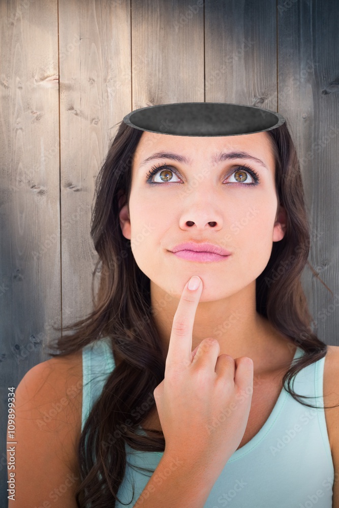 Composite image of pretty brunette looking up thoughfully