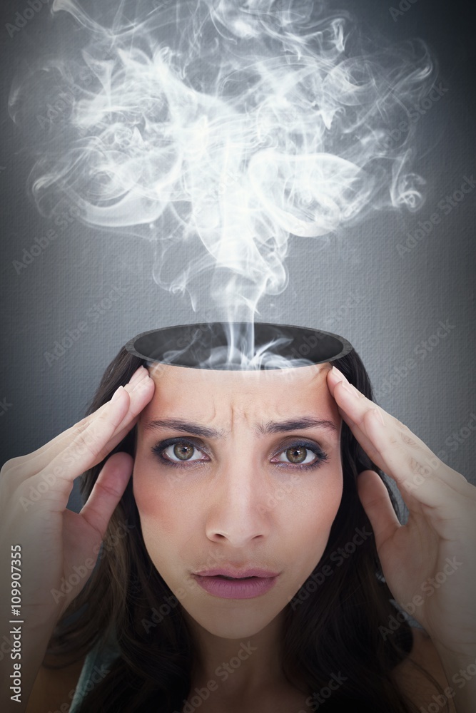 Composite image of pretty brunette with a headache