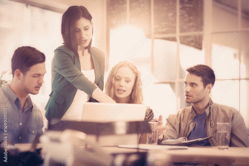 Group of young colleagues using laptop