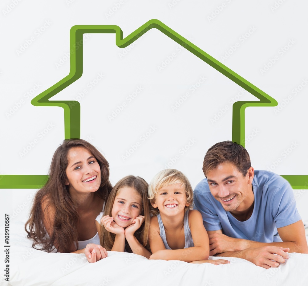 Composite image of happy family lying on a bed