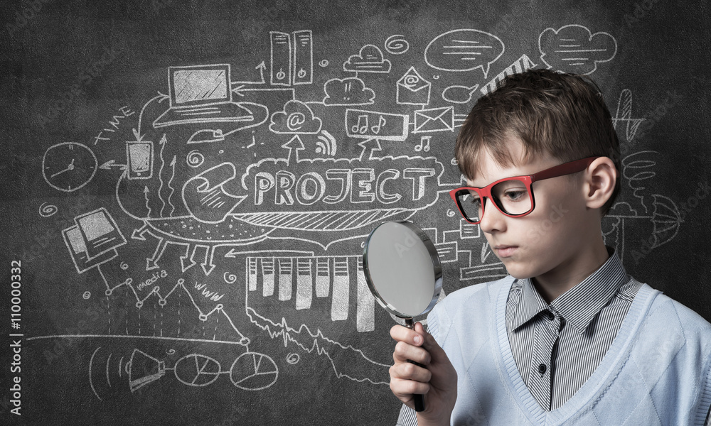 Curious school boy with magnifier