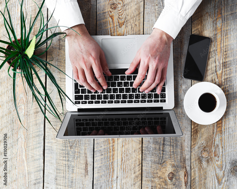 Mans working place at wooden table with office worker