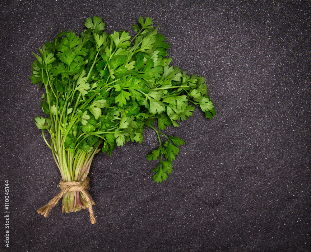 Fresh Green parsley on dark stone background