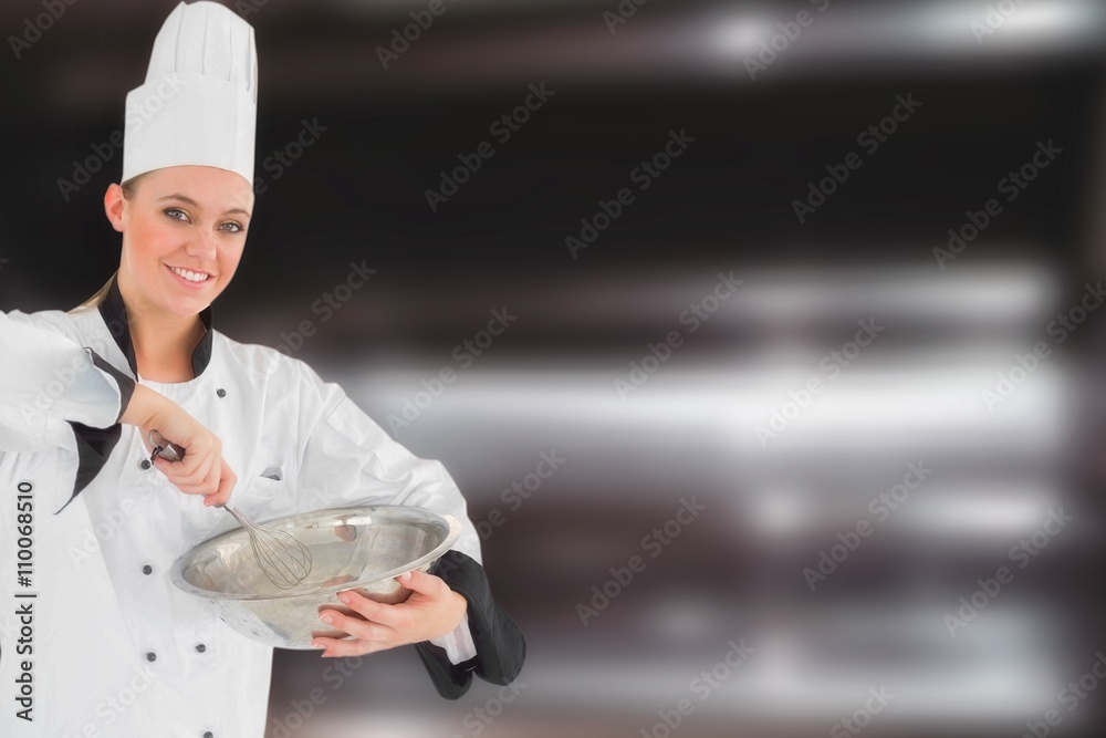 Composite image of happy female chef holding wire whisk and mixi