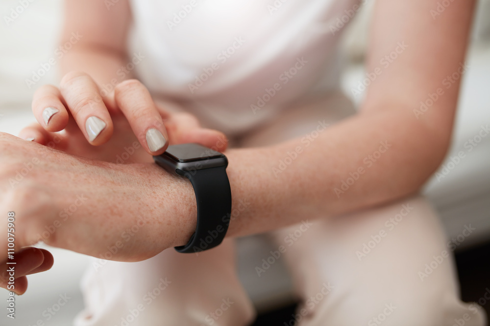 Woman checking time on her smart watch