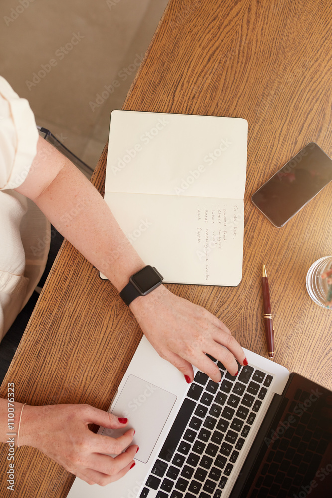 Woman sitting at her desk and working on laptop