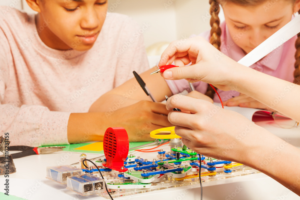 Hands of young student with potential probes