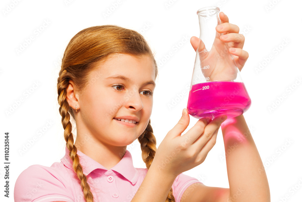 Young chemist pouring pink reagent in glass retort