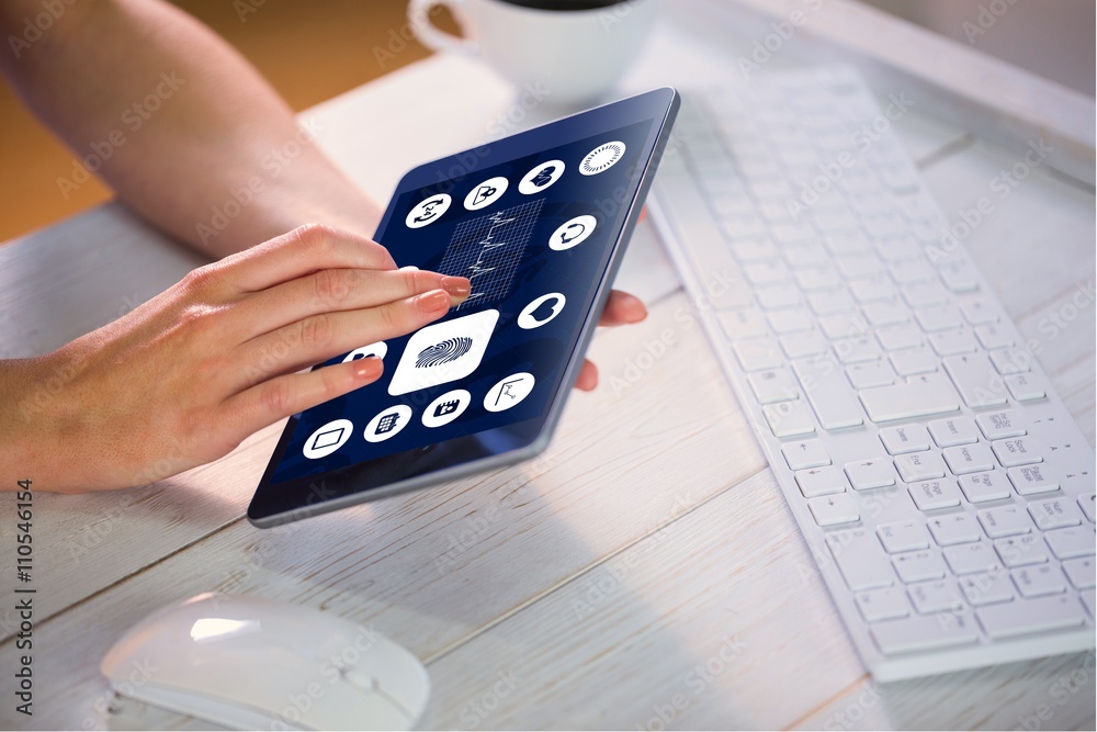 Composite image of woman using tablet at work