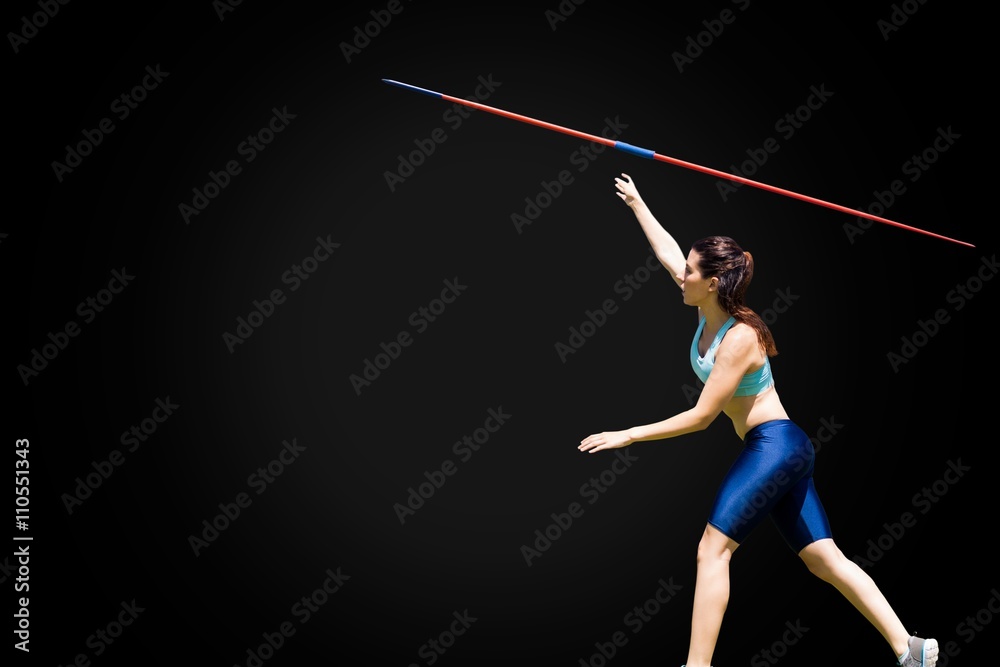 Profile view of sportswoman is practising javelin throw 