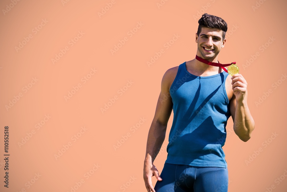 Composite image of attractive man showing medal