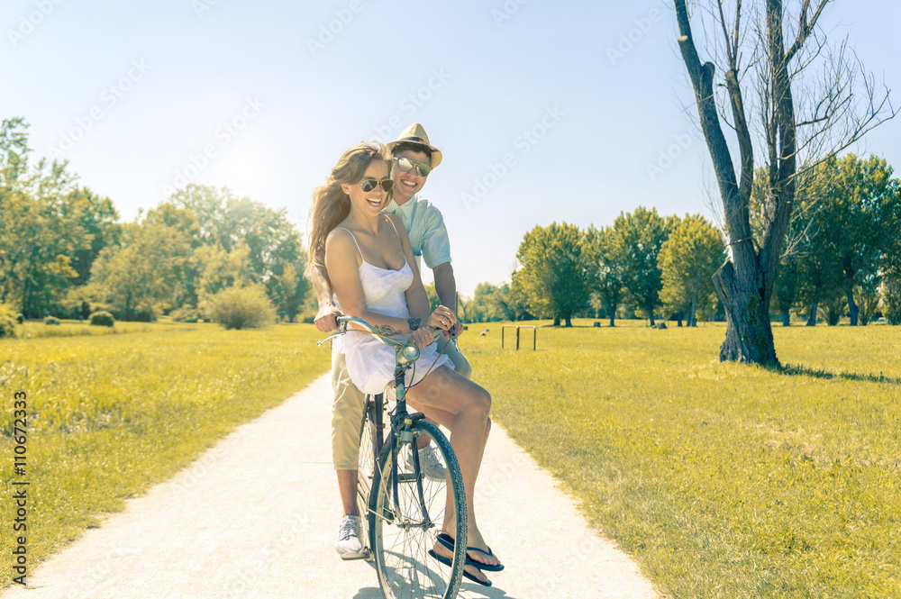 Hip young couple going for a bike ride on a sunny day 