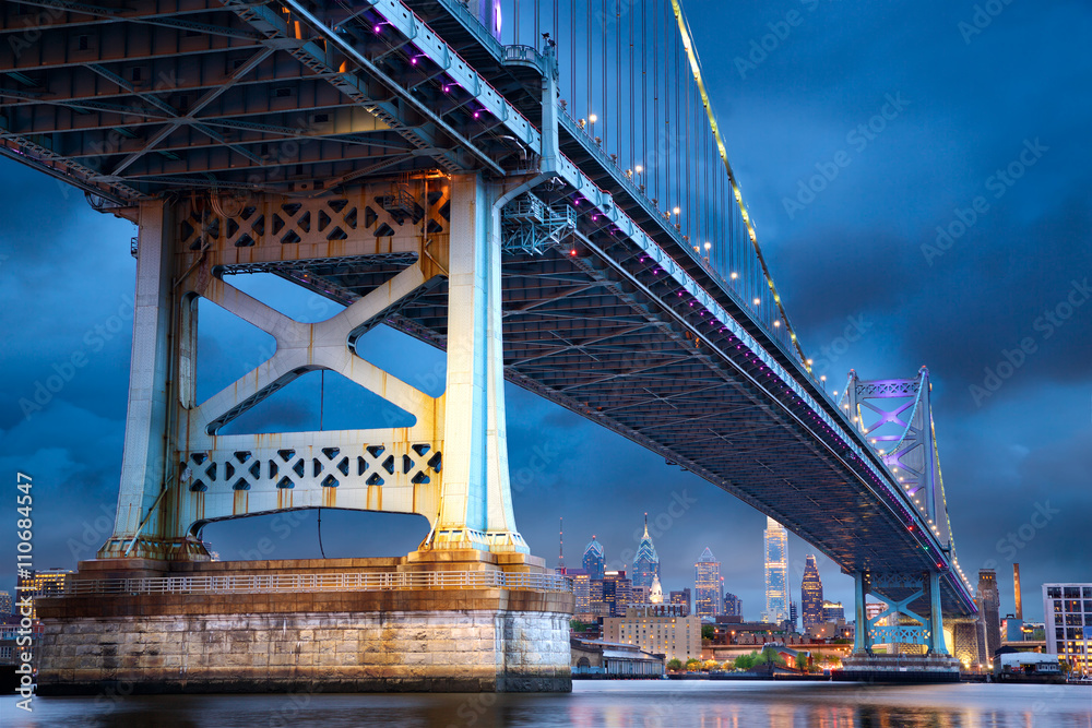 Ben Franklin Bridge above Philadelphia skyline at dusk, US