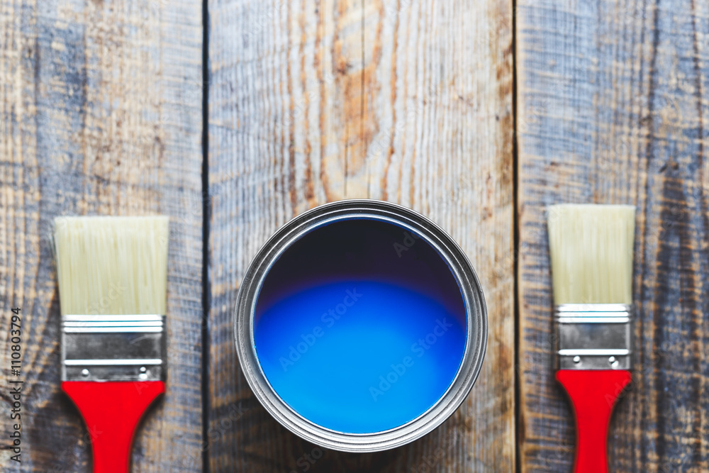 concept preparation for painting with  can of blue paint