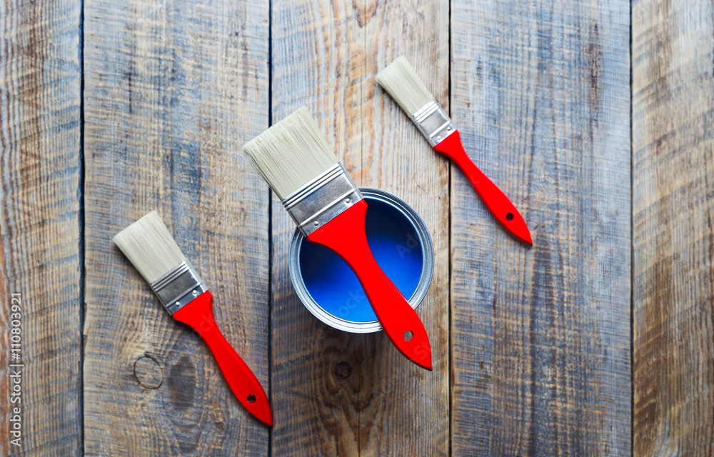 concept preparation for painting with  can of blue paint