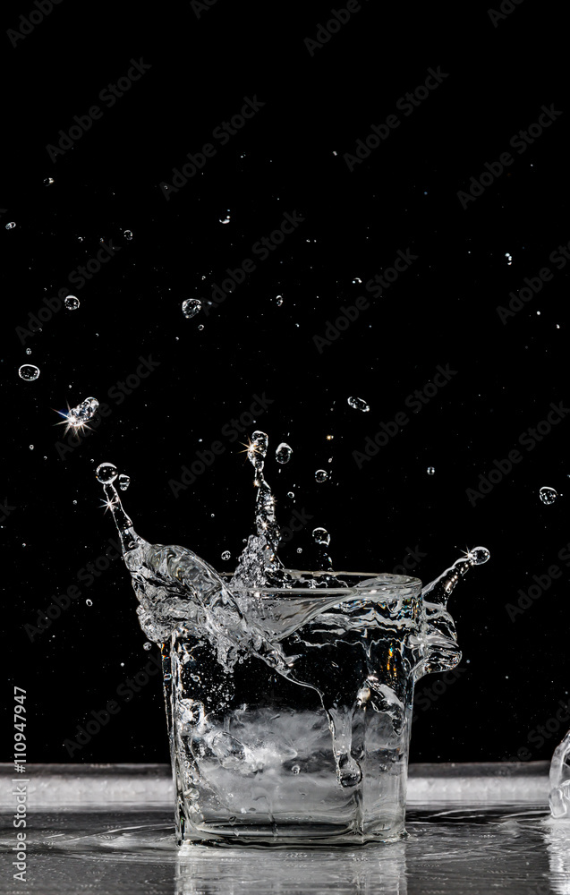 water splash in glass on black background