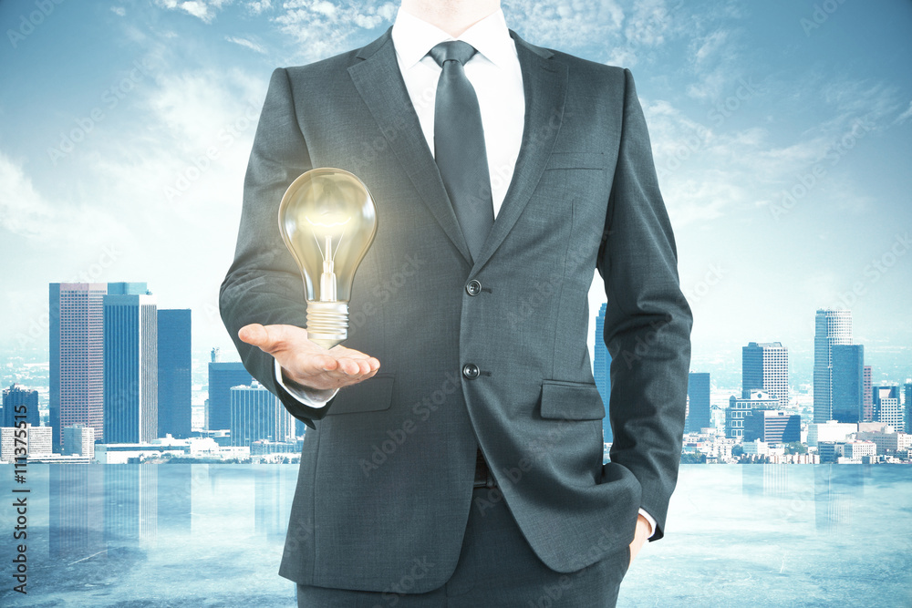 Businessman with lightbulb city background