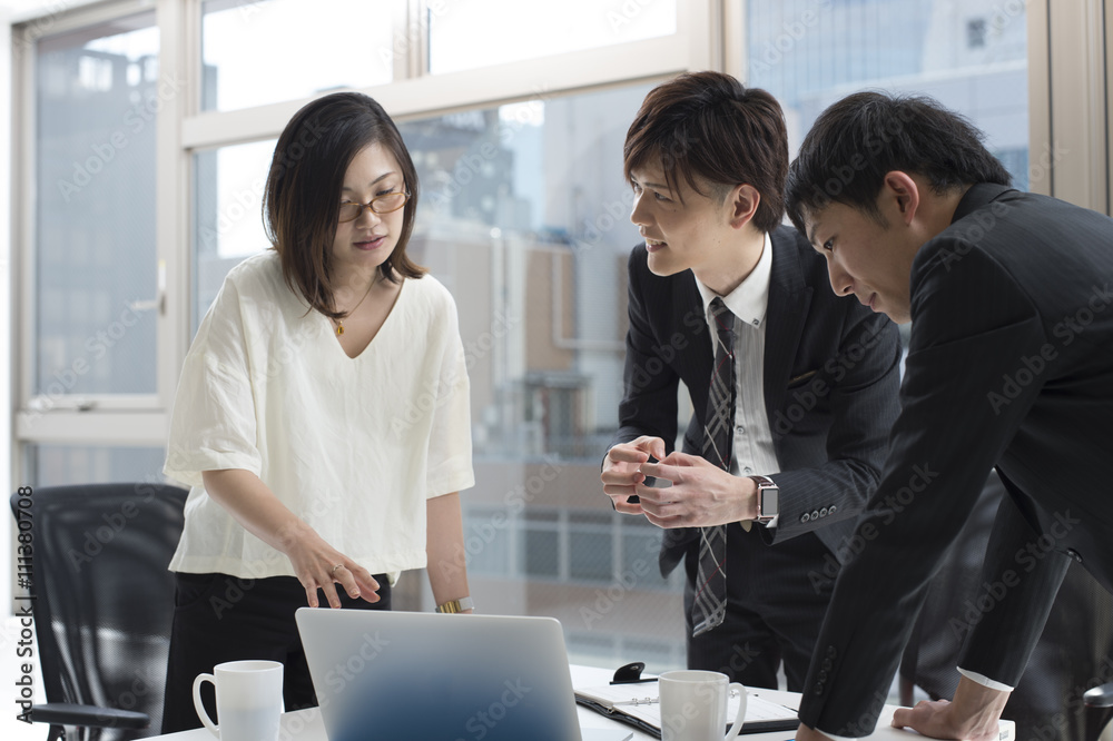 Three businessmen have a new product meeting at the office