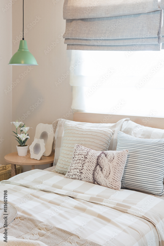 green lamp with vase of flower and picture frame on wooden table