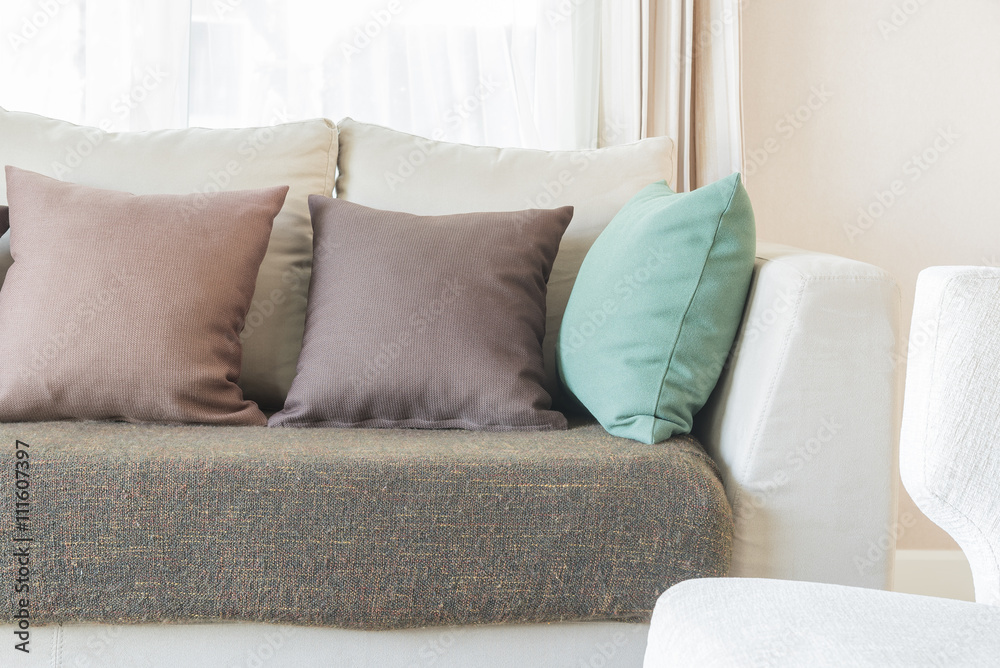 modern sofa and set of pillows in modern bedroom