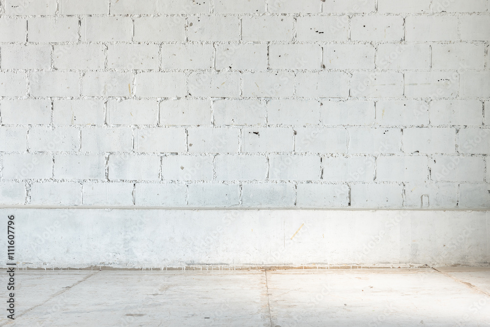 empty room with white brick wall and concrete floor