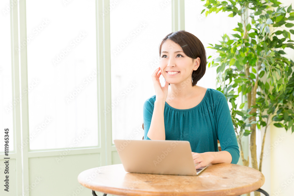 young asian woman using laptop in the cafe