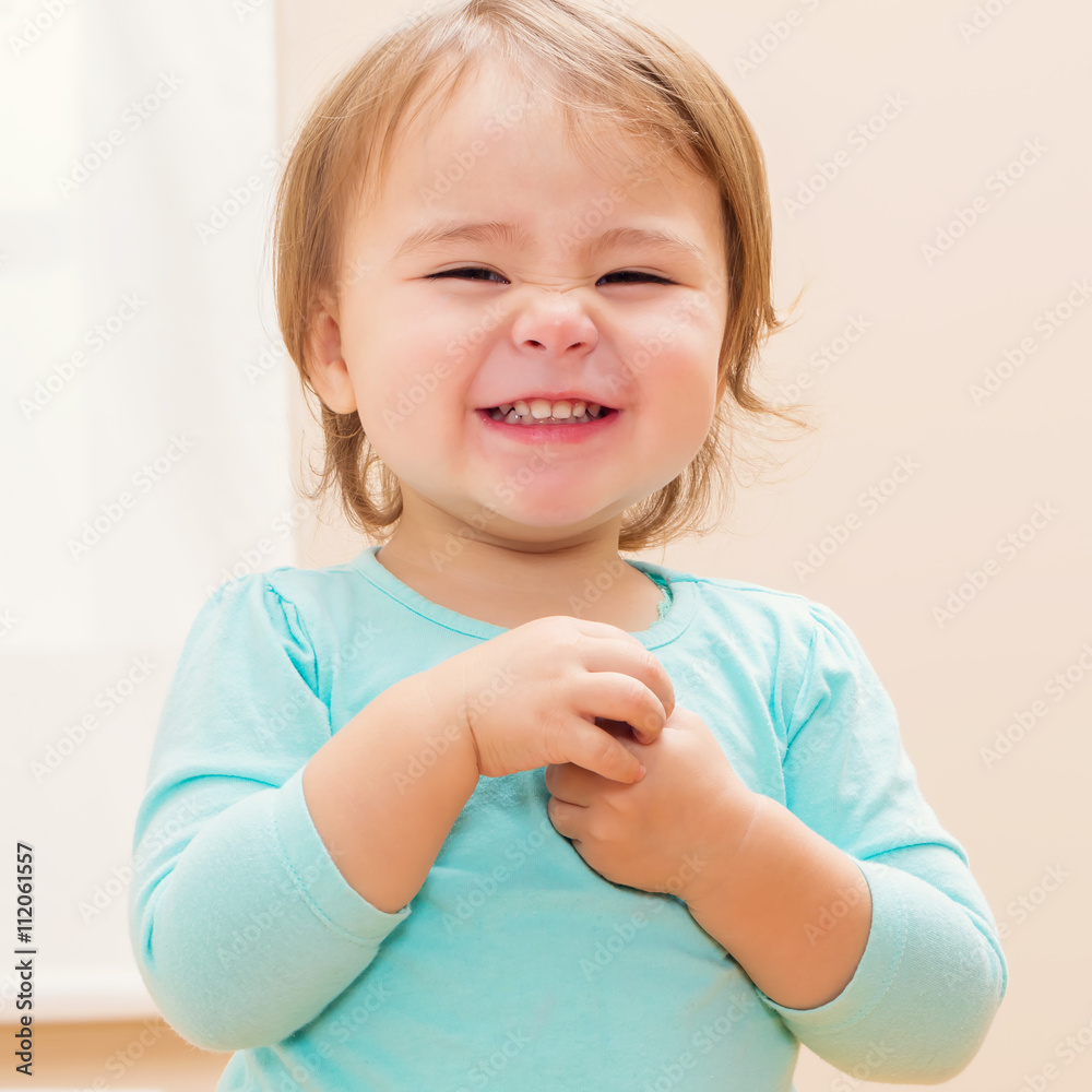 Happy toddler girl with a giant smile