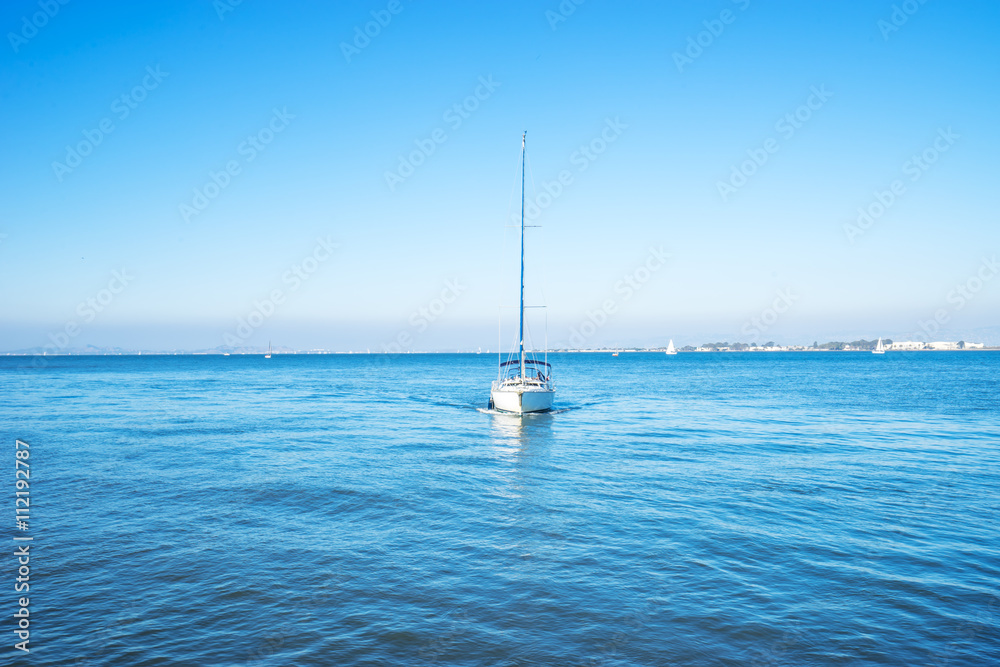 luxury sail boat on sea in blue sky