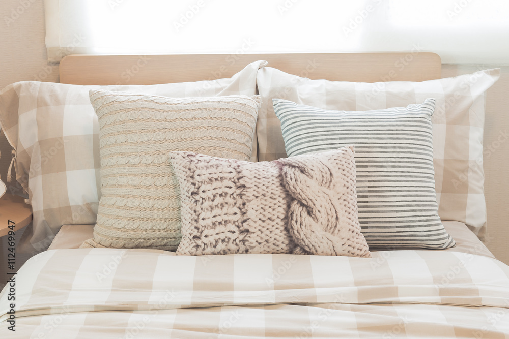 set of pillows on modern bed in modern bedroom